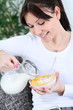 Photo: beautiful woman with a bowl of cereal beautiful woman with a bowl of cereal