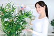 Photo: Beautiful woman cares for her flowers Beautiful woman cares for her flowers