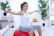 Young woman  doing fitness exercise with dumbbell