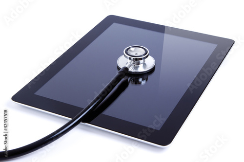 Photo: Digital tablet with stethoscope isolated on white Digital tablet with stethoscope isolated on white