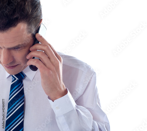 Photo: Cropped image of man talking on cell phone Cropped image of man talking on cell phone