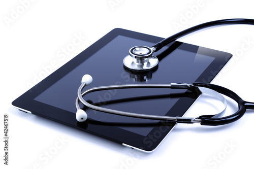 Photo: Digital tablet with stethoscope isolated on white Digital tablet with stethoscope isolated on white