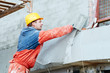 Builder at facade plastering works