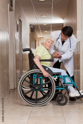 Photo: Doctor with Patient on Wheel Chair Doctor with Patient on Wheel Chair
