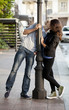 Foto: Young couple kissing on the street Young couple kissing on the street