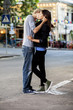 Foto: Young couple kissing on the street Young couple kissing on the street
