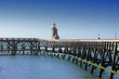 wooden pier and  lighthouse of the port of fécamps in france