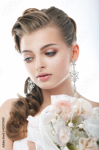 Photo: Beautiful young woman face. Wedding. Flowers. Beauty. Freshness Beautiful young woman face. Wedding. Flowers. Beauty. Freshness