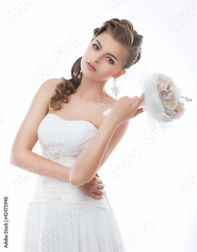 Photo: Beautiful girl in wedding dress isolated on white Beautiful girl in wedding dress isolated on white