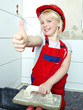Foto: Little girl with helmet showing thumb up for building a house Little girl with helmet showing thumb up for building a house