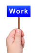 Photo: Road sign in hand with word work. Road sign in hand with word work.