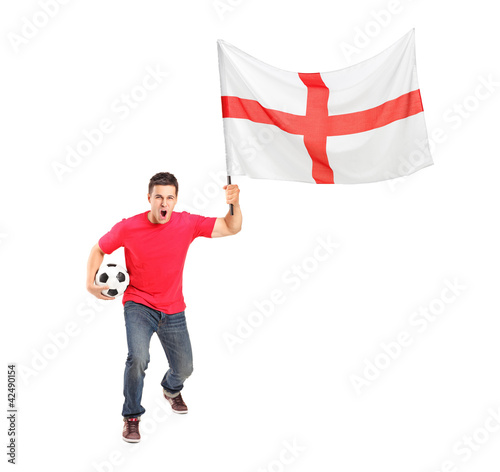 Photo: Full length portrait of an euphoric fan holding a ball and Engli Full length portrait of an euphoric fan holding a ball and Engli