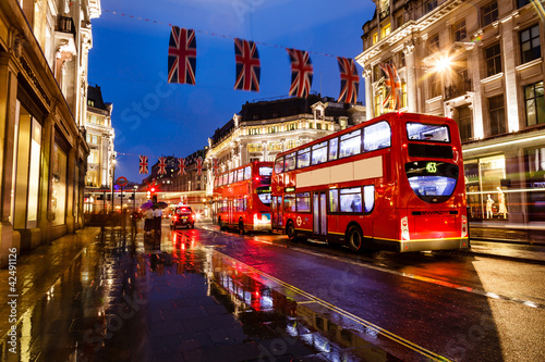 Red Bus on the Rainy Street of London in the Night, United Kingd