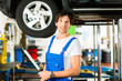 Mechaniker in Werkstatt arbeitet an Auto