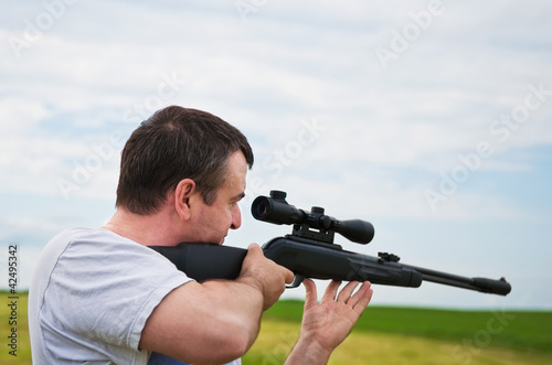 Photo: man shooting man shooting