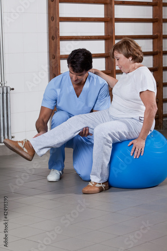 Photo: Physical Therapist helping a Patient Physical Therapist helping a Patient