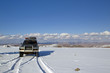 Car going over mountain pass in snow, Mongolia