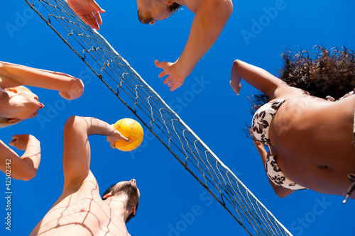 Photo: Friends playing beach volleyball Friends playing beach volleyball