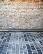 brick wall and cobblestone street