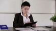 Young punk businesswoman with tablet computer in the office