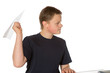 Foto: Teenager taking aim with a paper plane Teenager taking aim with a paper plane