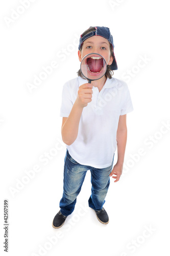 Photo: boy looking through a magnifying glass boy looking through a magnifying glass