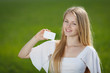Young girl holding a blank credit card outdoor