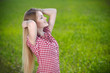 Young woman relaxing with hands behind her head