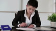 Young punk businesswoman signing documents in the office