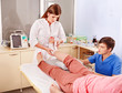 Doctor bandaging patient in hospital.