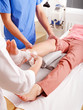 Doctor bandaging patient in hospital.