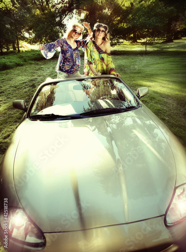 Photo: smiling women in a convertible car smiling women in a convertible car