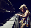girl playing on an  piano.