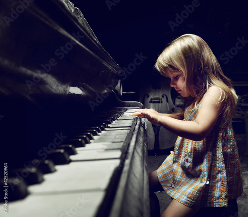 Photo: girl playing on an piano. girl playing on an piano.