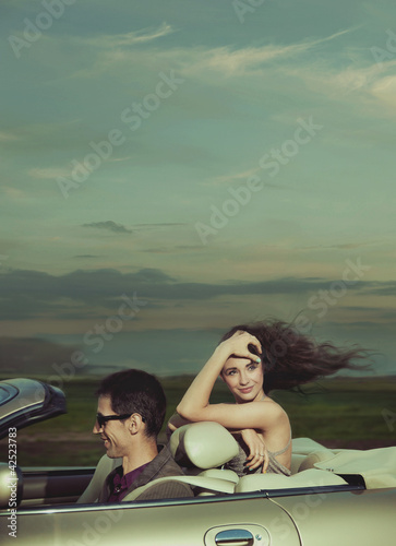 Photo: Young couple in cabriolet Young couple in cabriolet