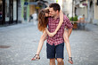 Young man giving piggyback ride to his girlfriend