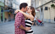 Young couple in love, hugging on the street. Selective focus.