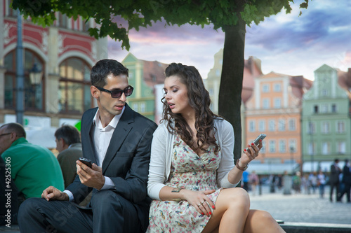 Photo: Handsome couple with mobile Handsome couple with mobile