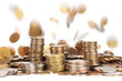 Photo: stacks of silver and golden coins and falling coins on backgroun stacks of silver and golden coins and falling coins on backgroun