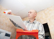 guy glues ceiling tile