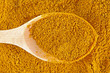 Photo: Curry spice with wooden spoon Curry spice with wooden spoon