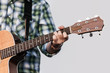 Human hand holding guitar music instrument