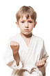 Child boy in kimono training karate