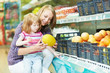 woman and little girl shopping fruits