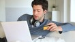 Young man buying music on internet with tablet