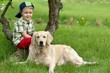 Photo: A little boy and dog on garden A little boy and dog on garden