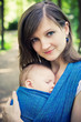 mother with newborn baby in a sling