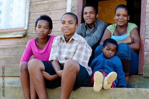 Photo: Family on the porch in front of their home. Family on the porch in front of their home.