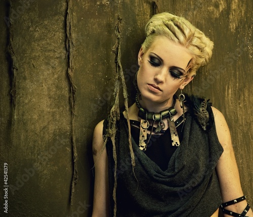 Photo: Blond girl against grunge wall Blond girl against grunge wall