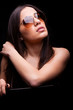 Photo: close-up portrait of sexy woman in sunglasses over dark backgrou close-up portrait of sexy woman in sunglasses over dark backgrou